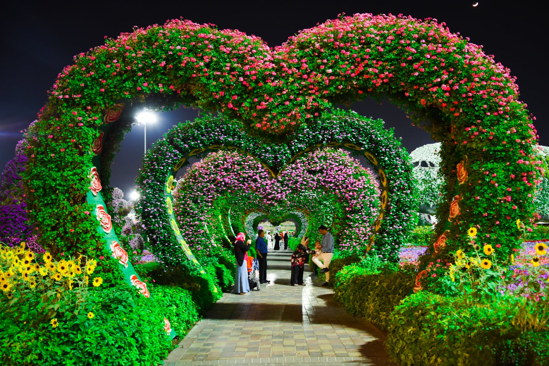 Heart-shaped flower garden filled with pink and purple flowers